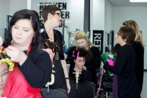 Greenville students practice hair curling